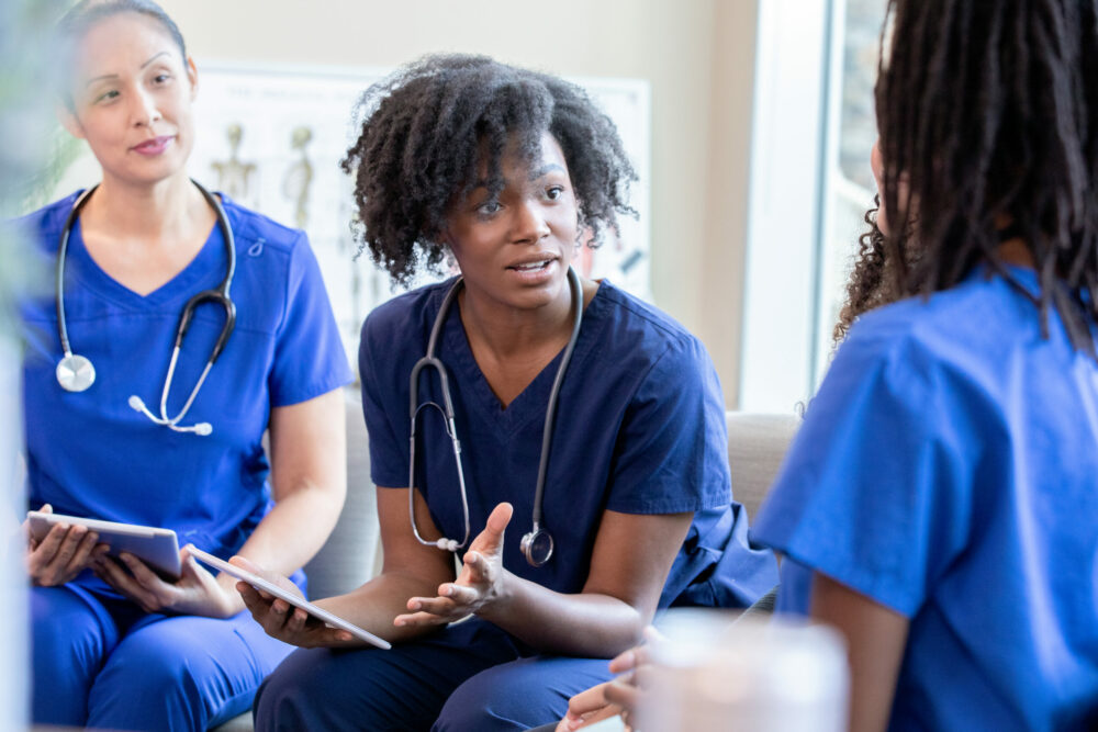 Diverse medical staff meeting in hospital to discuss nursing program